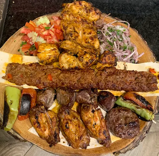 Mixed grill platter with Adana kebab, chicken skewers and grilled vegetables